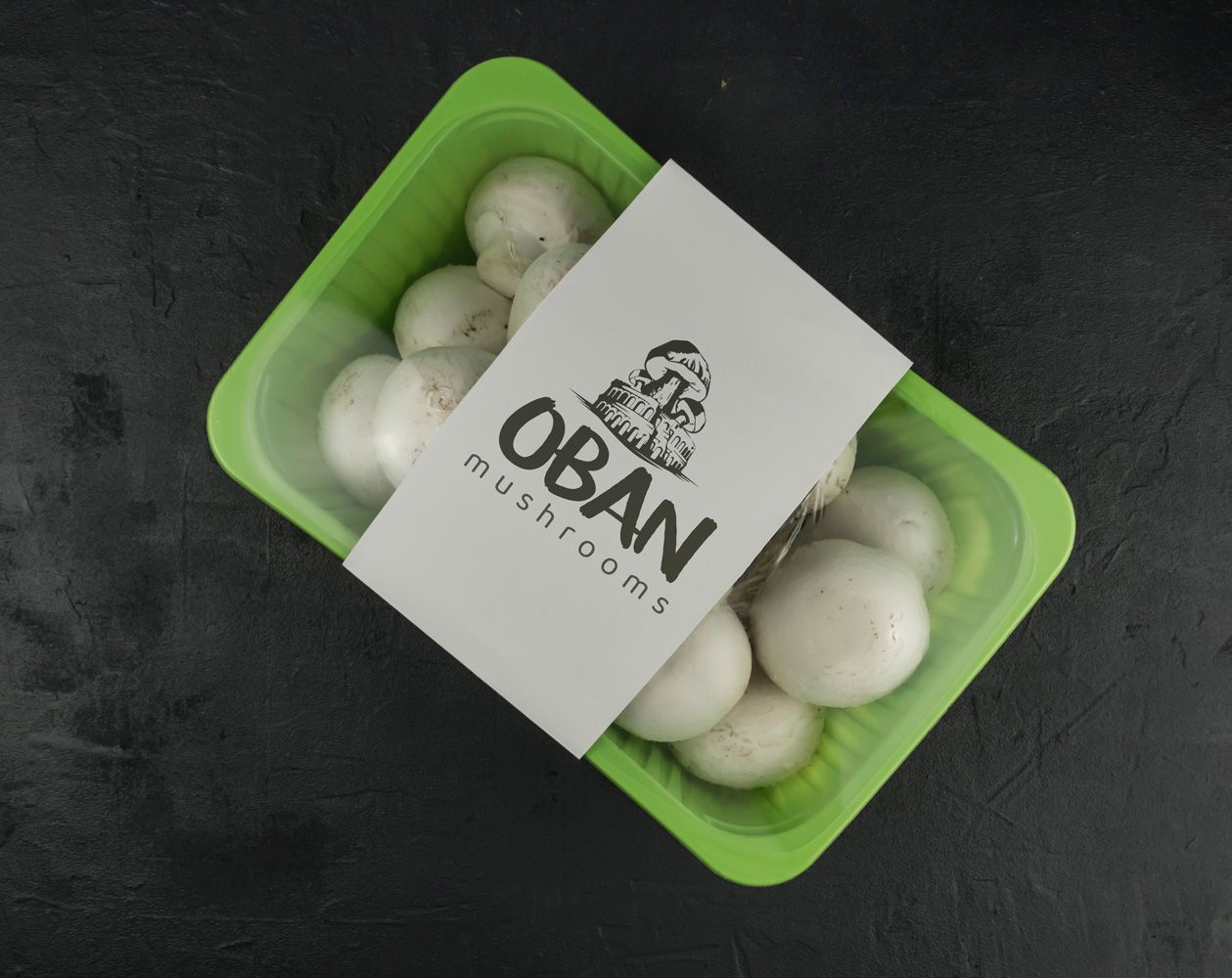 Oban Mushrooms logo printed on a punnet of fresh mushrooms